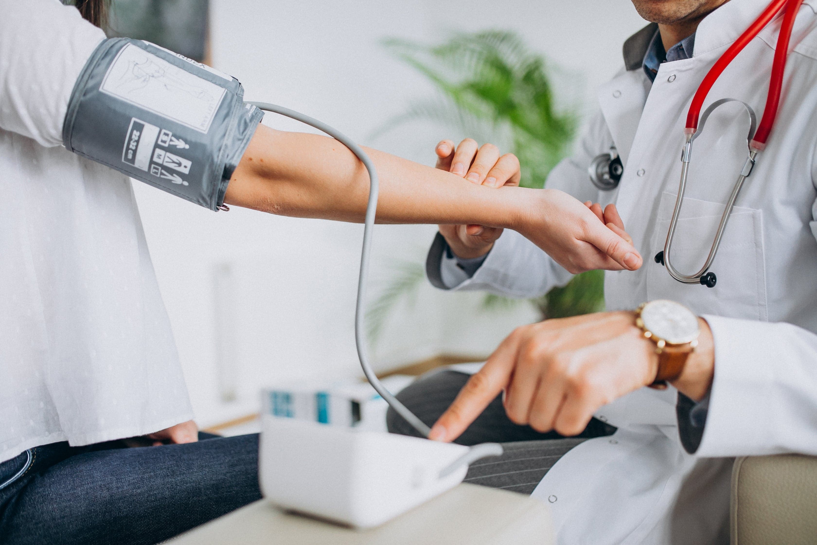 A clinician taking a patient's blood pressure